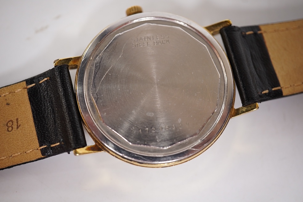 A gentleman's steel and gold plated Longines Conquest manual wind wrist watch, with baton numerals and date aperture, case diameter 35mm, together with a gentleman's stainless steel Marvin manual wind wrist watch, case d